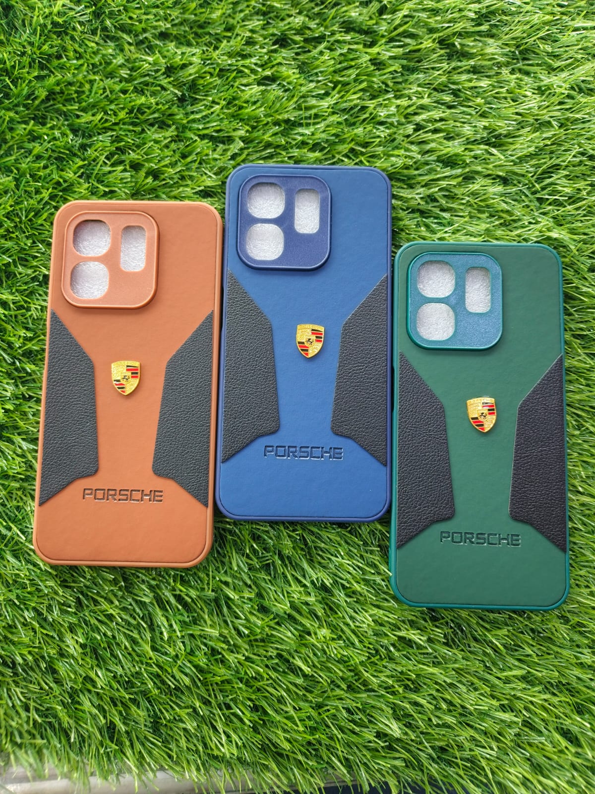 Three Porsche phone cases in brown, blue, and green on grass, Infinix Hot 50i leather touch round cut camera case blue
Infinix Smart 9 leather finish round cut cover orange
Premium green leather touch round cut back cover for Infinix Hot 50i & Smart 9